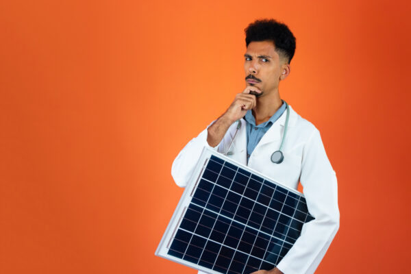 Black Young Doctor Medical Resident With Stethoscope Holding Solar Panel