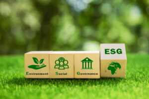 ESG concept of environmental, social and governance. It is an idea for sustainable organizational development. wooden cube with text ESG surrounding with ESG icon on beautiful green background.