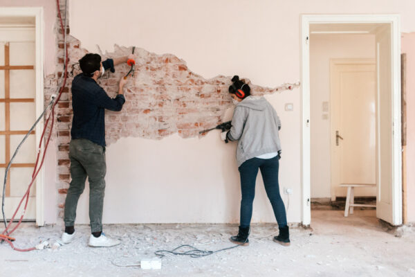 Young couple working on reconstruction of their apartment